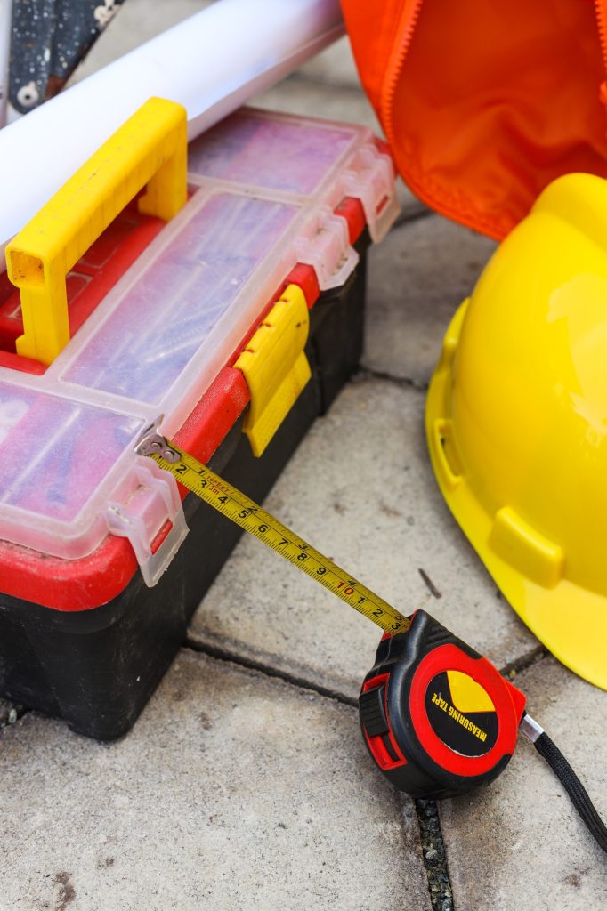 Engineer toolbox with yellow hard safety helmet