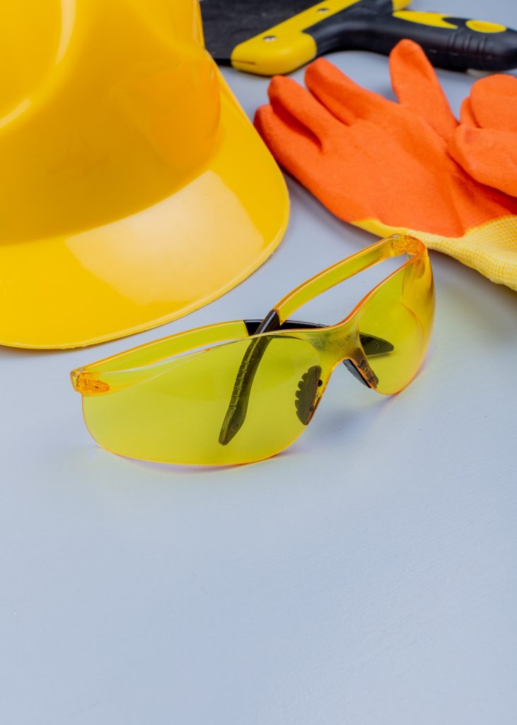 side view of pattern from set of construction tools as safety glasses gloves safety helmet